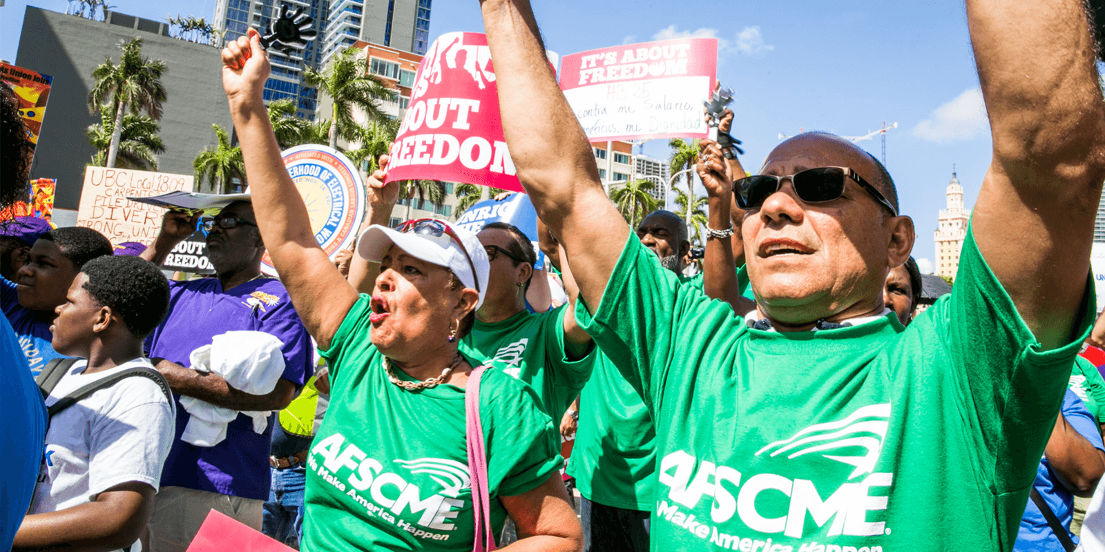 AFSCME members at Florida rally holding signs reading "It's about freedom." 